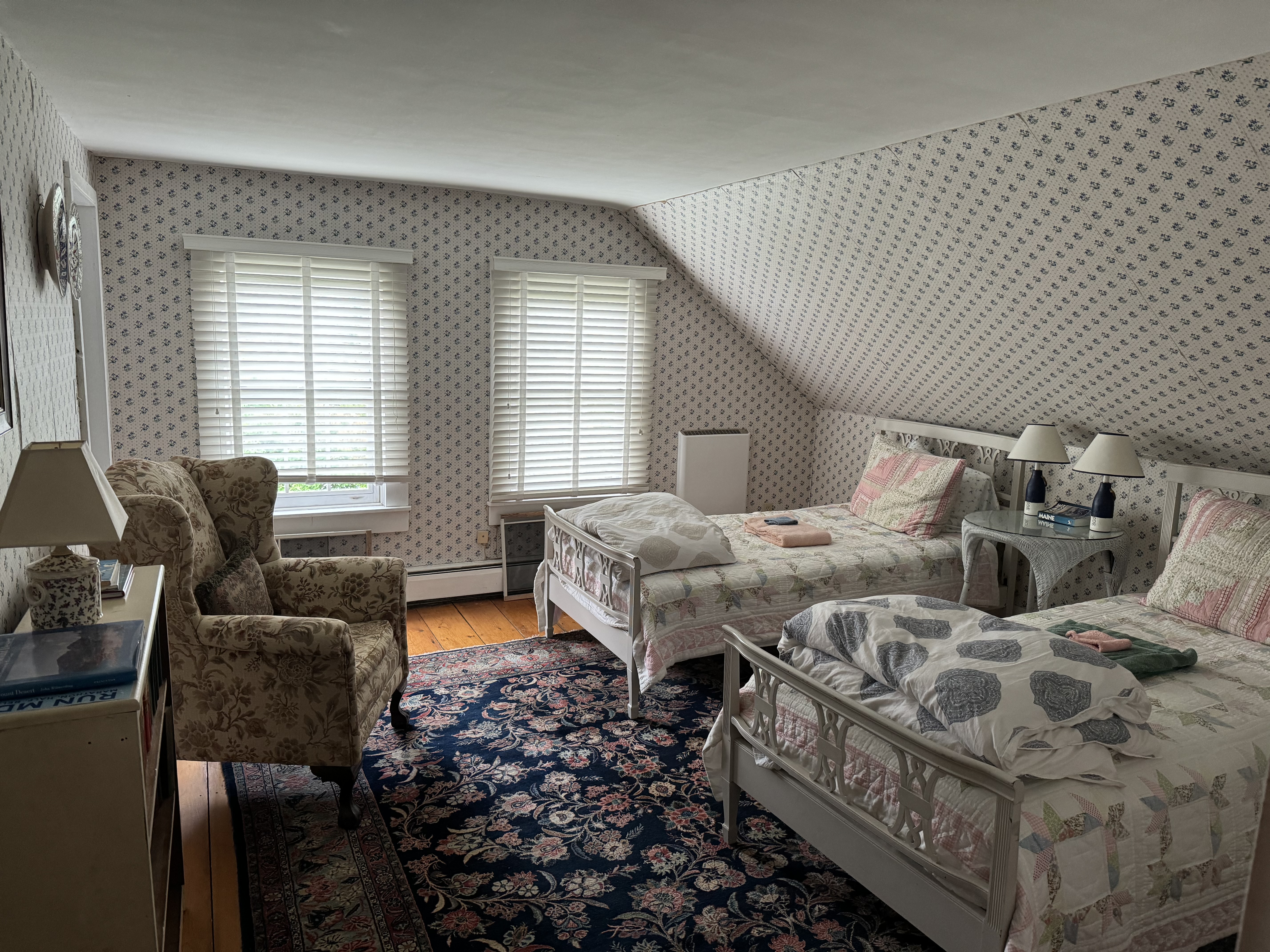 Bedroom with floral wallpaper and twin beds