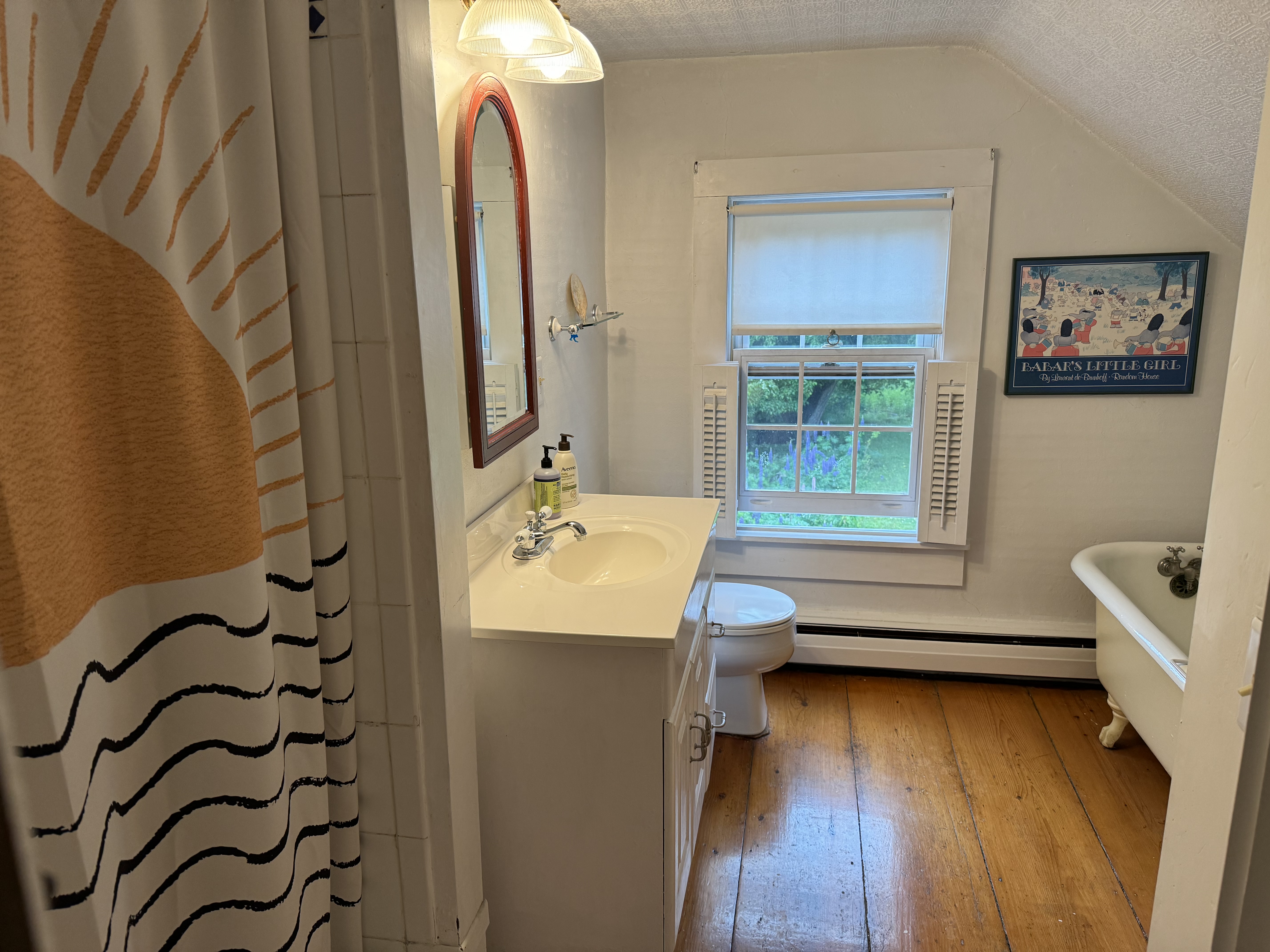 Bathroom with clawfoot tub and original pine floors