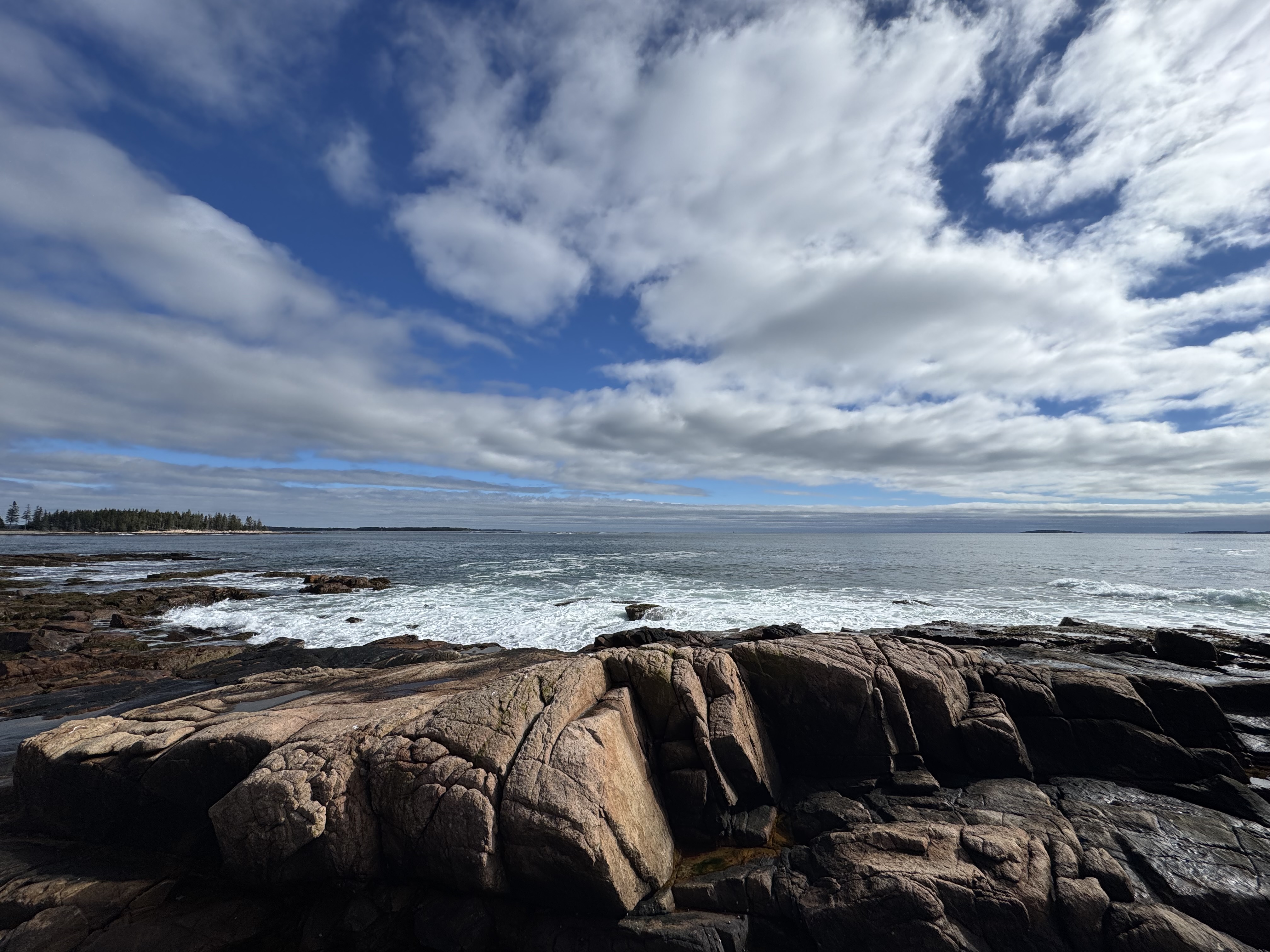 Pink granite ledges and crashing surf