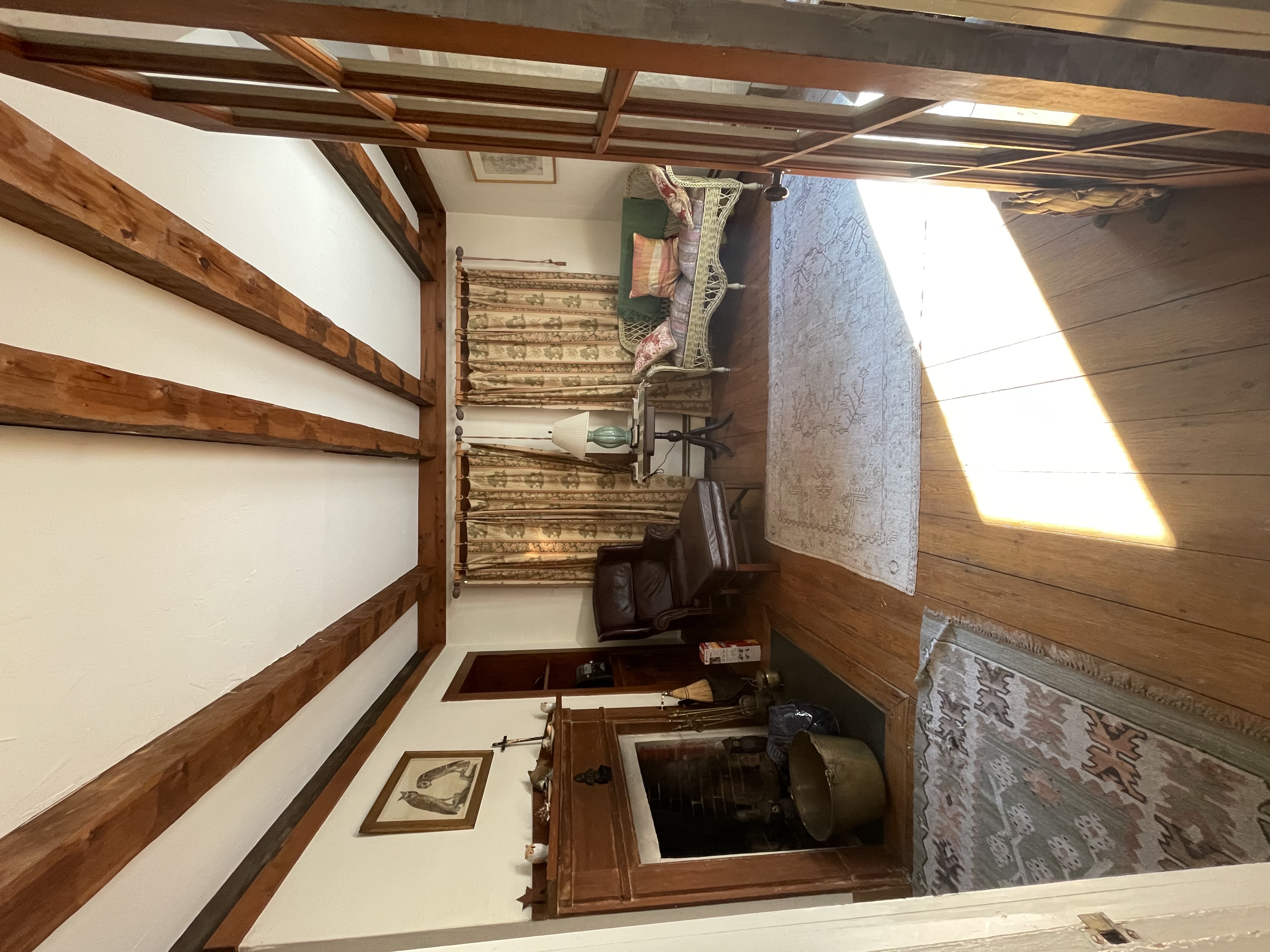 Living room with exposed beams and fireplace